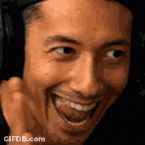 A Close Up Of A Man 'S Face Making A Funny Face With His Tongue Out . GIF