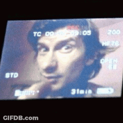 A Close Up Of A Man 'S Face On A Screen That Says Tc 09 GIF