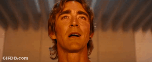 A Close Up Of A Man 'S Face Smiling And Looking Up At The Sky . GIF