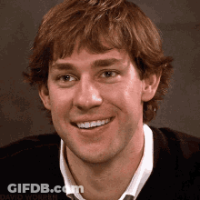 A Close Up Of A Man 'S Face Smiling With The Name David Worren In The Corner GIF