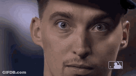 A Close Up Of A Man 'S Face Wearing A Baseball Cap And Looking At The Camera . GIF