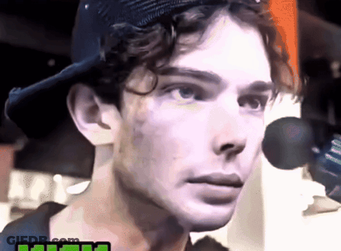 A Close Up Of A Man 'S Face Wearing A Baseball Cap GIF