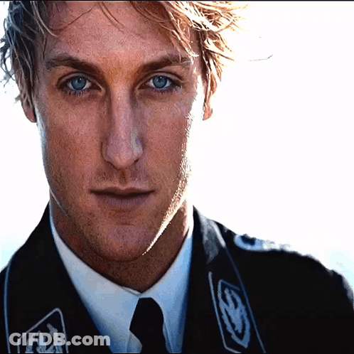 A Close Up Of A Man 'S Face Wearing A Black Jacket GIF
