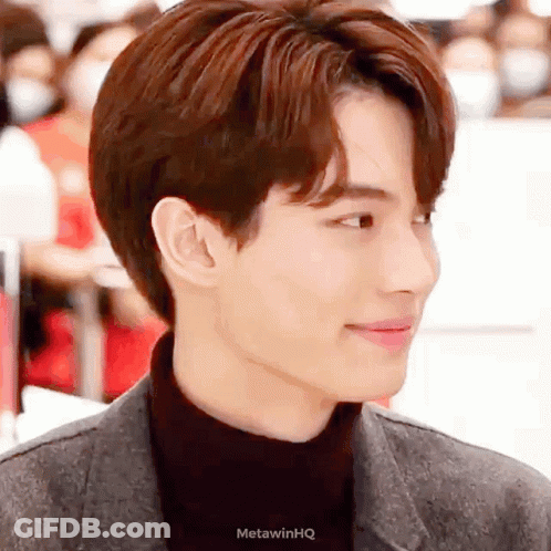 A Close Up Of A Man 'S Face Wearing A Black Turtleneck And A Jacket . GIF