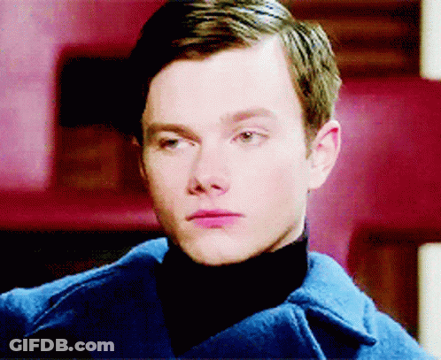 A Close Up Of A Man 'S Face Wearing A Blue Coat GIF