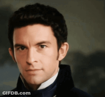 A Close Up Of A Man 'S Face Wearing A Blue Jacket GIF