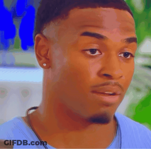 A Close Up Of A Man 'S Face Wearing A Blue Shirt GIF
