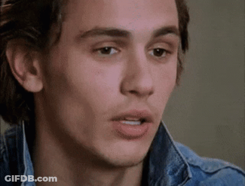 A Close Up Of A Man 'S Face Wearing A Denim Jacket And Making A Funny Face . GIF