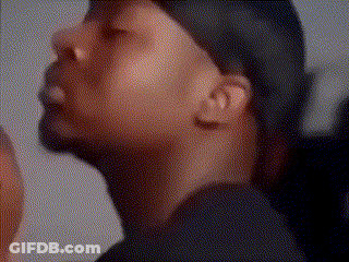 A Close Up Of A Man 'S Face Wearing A Hat And A Black Shirt . GIF