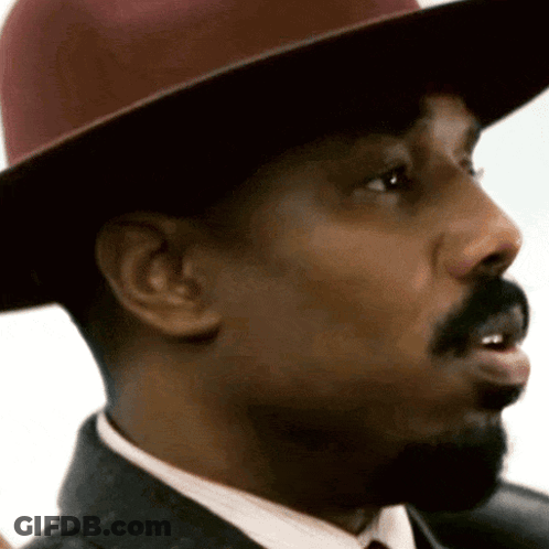 A Close Up Of A Man 'S Face Wearing A Hat GIF