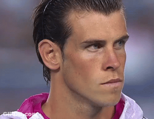 A Close Up Of A Man 'S Face Wearing A Pink Jacket GIF