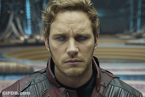 A Close Up Of A Man 'S Face Wearing A Red Leather Jacket GIF