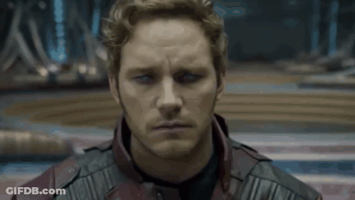 A Close Up Of A Man 'S Face Wearing A Red Leather Jacket GIF