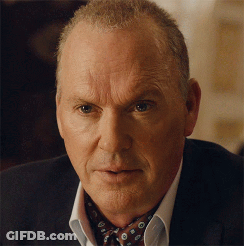 A Close Up Of A Man 'S Face Wearing A Suit And Bow Tie GIF