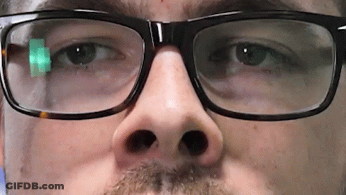 A Close Up Of A Man 'S Face Wearing Glasses And A Beard GIF