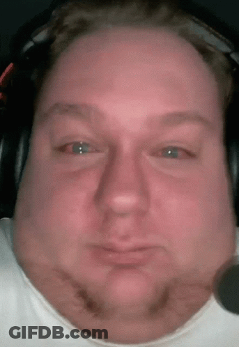 A Close Up Of A Man 'S Face Wearing Headphones And A White Shirt GIF