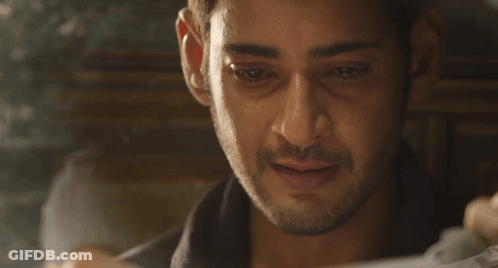 A Close Up Of A Man 'S Face While Looking At A Piece Of Paper . GIF