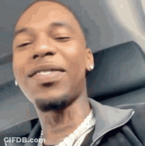 A Close Up Of A Man 'S Face While Sitting On An Airplane With His Eyes Closed . GIF