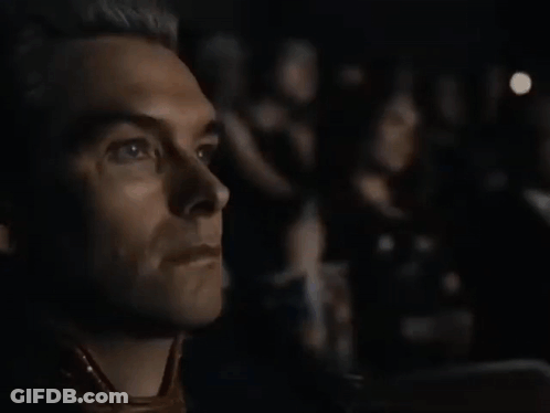 A Close Up Of A Man 'S Face While Watching A Movie . GIF