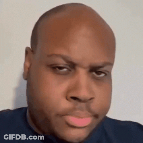 A Close Up Of A Man 'S Face With A Bald Head And A Pink Lip . GIF