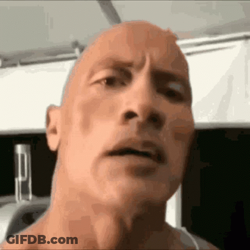 A Close Up Of A Man 'S Face With A Bald Head And A Serious Look On His Face . GIF