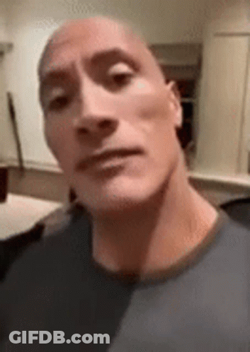 A Close Up Of A Man 'S Face With A Bald Head Making A Funny Face . GIF