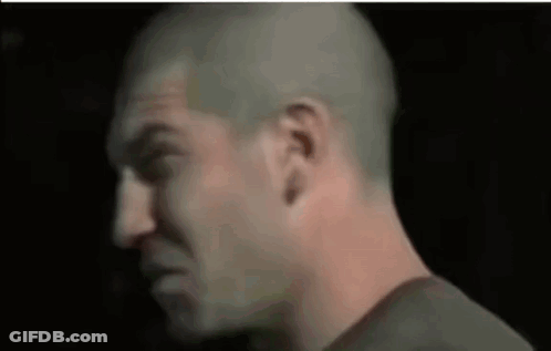 A Close Up Of A Man 'S Face With A Bald Head GIF