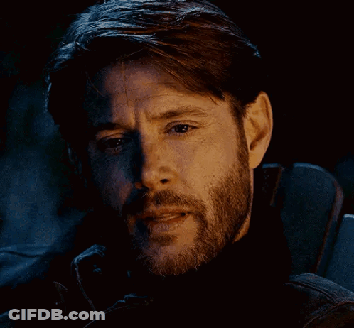 A Close Up Of A Man 'S Face With A Beard And A Black Jacket . GIF
