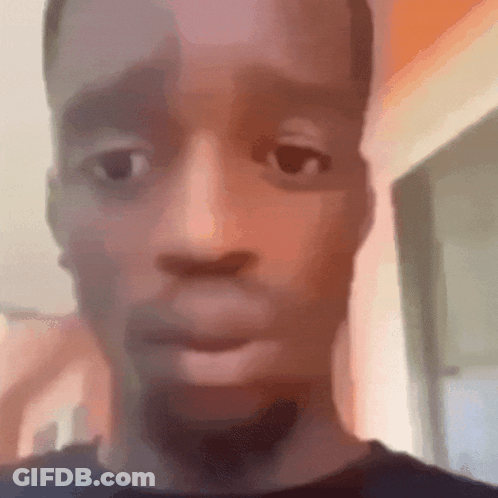 A Close Up Of A Man 'S Face With A Beard And A Blurred Background . GIF