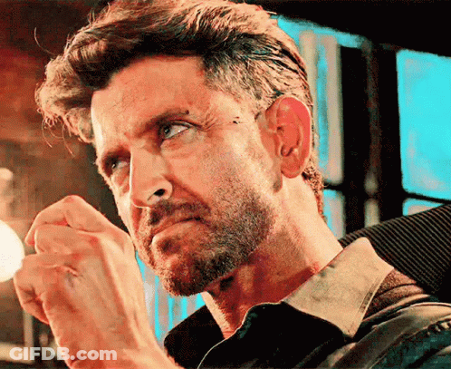 A Close Up Of A Man 'S Face With A Beard And A Piercing In His Ear GIF
