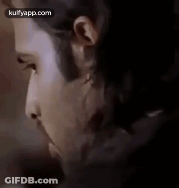 A Close Up Of A Man 'S Face With A Beard And A Piercing In His Ear . GIF