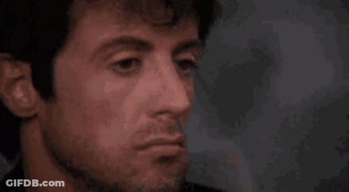 A Close Up Of A Man 'S Face With A Beard And A Red Nose . GIF