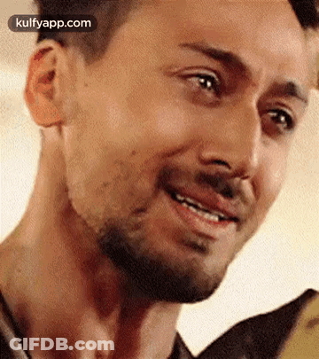 A Close Up Of A Man 'S Face With A Beard And A Smile . GIF