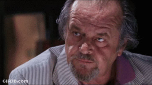 A Close Up Of A Man 'S Face With A Beard And A Striped Shirt GIF