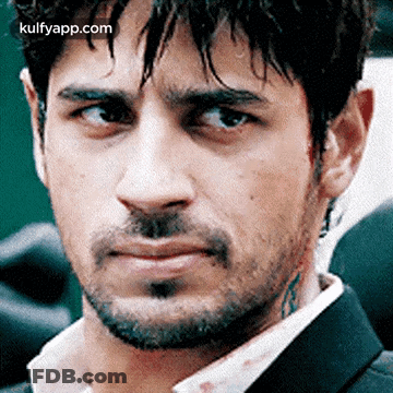 A Close Up Of A Man 'S Face With A Beard And A Tattoo On His Neck GIF