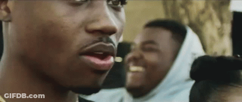 A Close Up Of A Man 'S Face With A Beard And A Woman 'S Head In The Background . GIF
