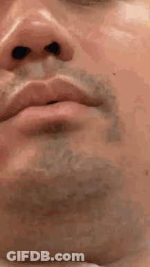 A Close Up Of A Man 'S Face With A Beard And Black Eyes GIF