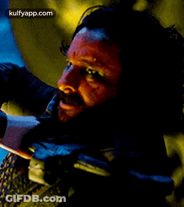 A Close Up Of A Man 'S Face With A Beard And Blood On It . GIF
