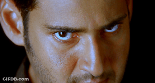A Close Up Of A Man 'S Face With A Beard And Blue Eyes GIF