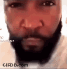 A Close Up Of A Man 'S Face With A Beard And Bow Tie . GIF