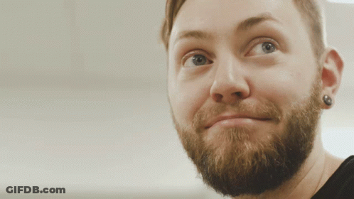 A Close Up Of A Man 'S Face With A Beard And Earring GIF