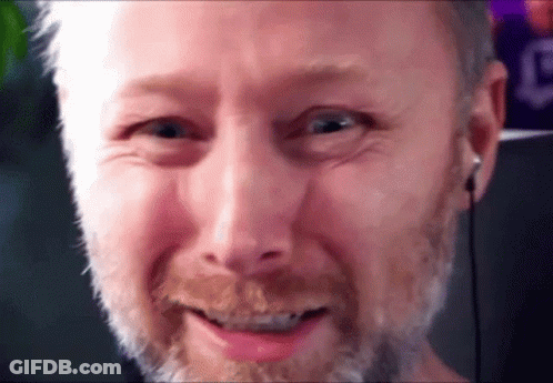 A Close Up Of A Man 'S Face With A Beard And Headphones . GIF