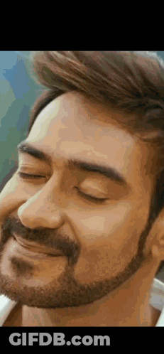 A Close Up Of A Man 'S Face With A Beard And His Eyes Closed . GIF