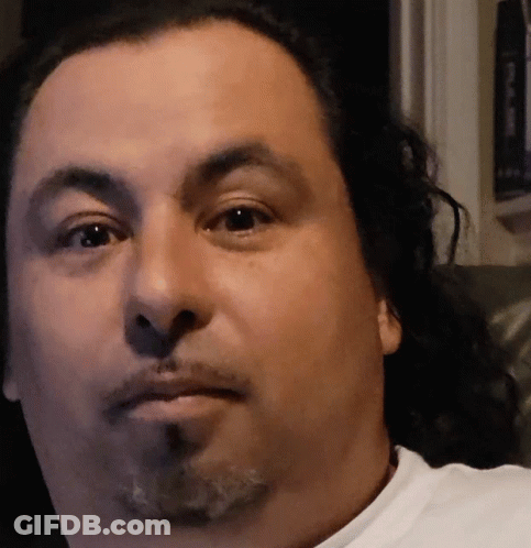 A Close Up Of A Man 'S Face With A Beard And Long Hair GIF