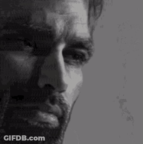 A Close Up Of A Man 'S Face With A Beard And Mustache . GIF