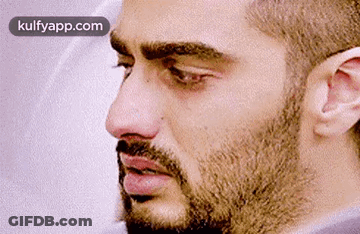 A Close Up Of A Man 'S Face With A Beard And Mustache . GIF