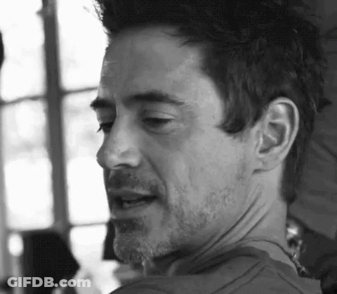 A Close Up Of A Man 'S Face With A Beard And Mustache In A Black And White Photo . GIF
