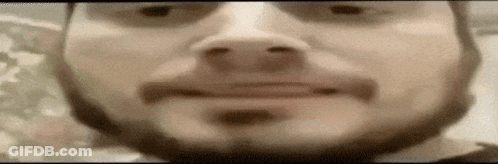 A Close Up Of A Man 'S Face With A Beard And Sunglasses On . GIF