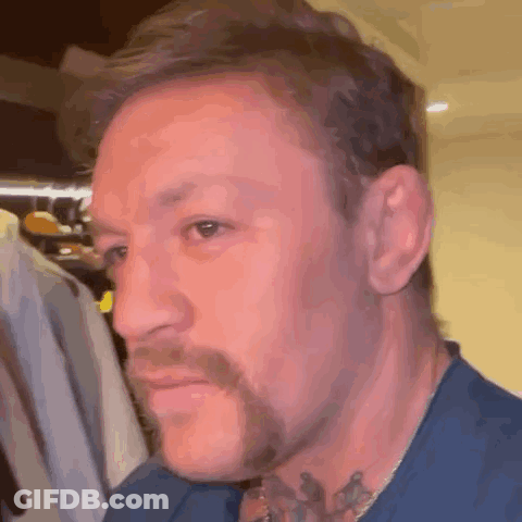 A Close Up Of A Man 'S Face With A Beard And Tattoos . GIF
