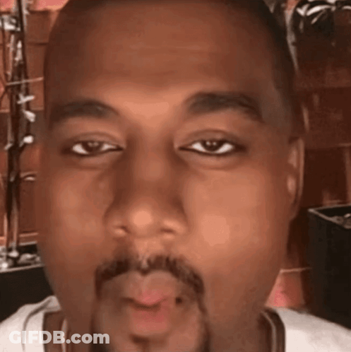 A Close Up Of A Man 'S Face With A Beard Blowing A Kiss GIF